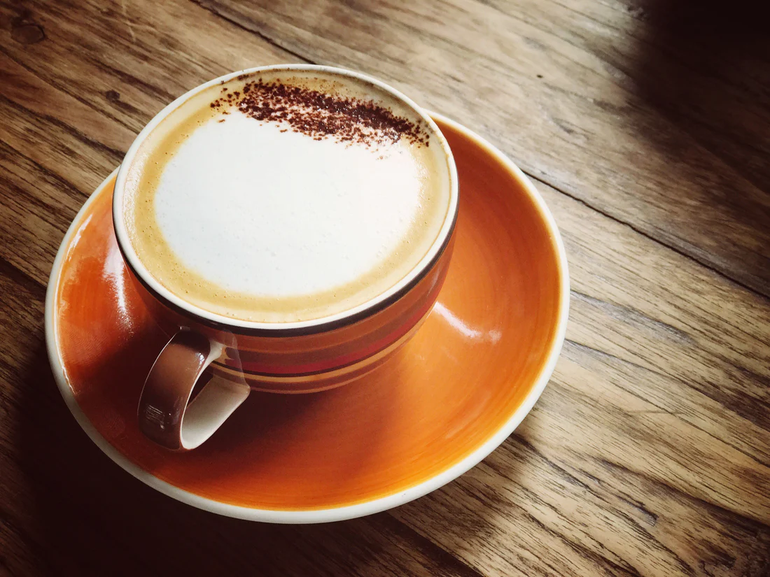 Cappuccino with latte art in a white cup